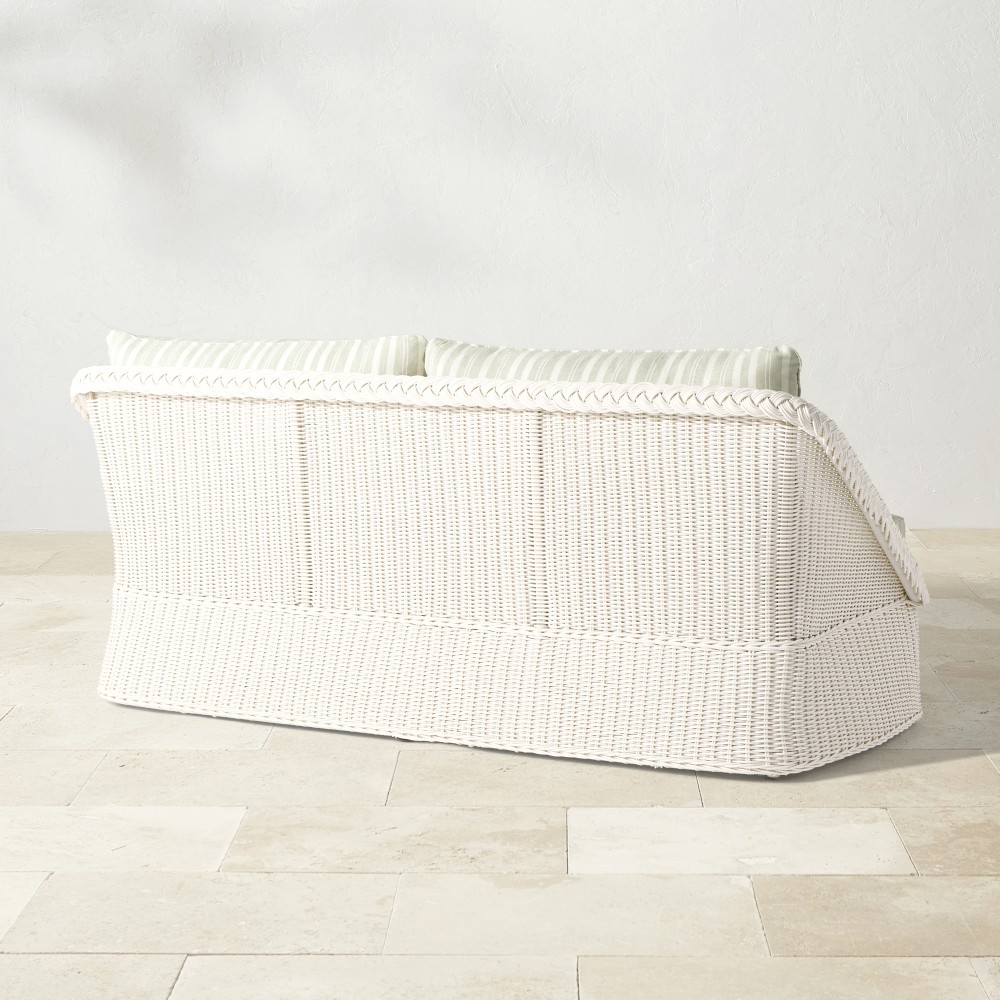 Rear/side view of white wicker outdoor sofa