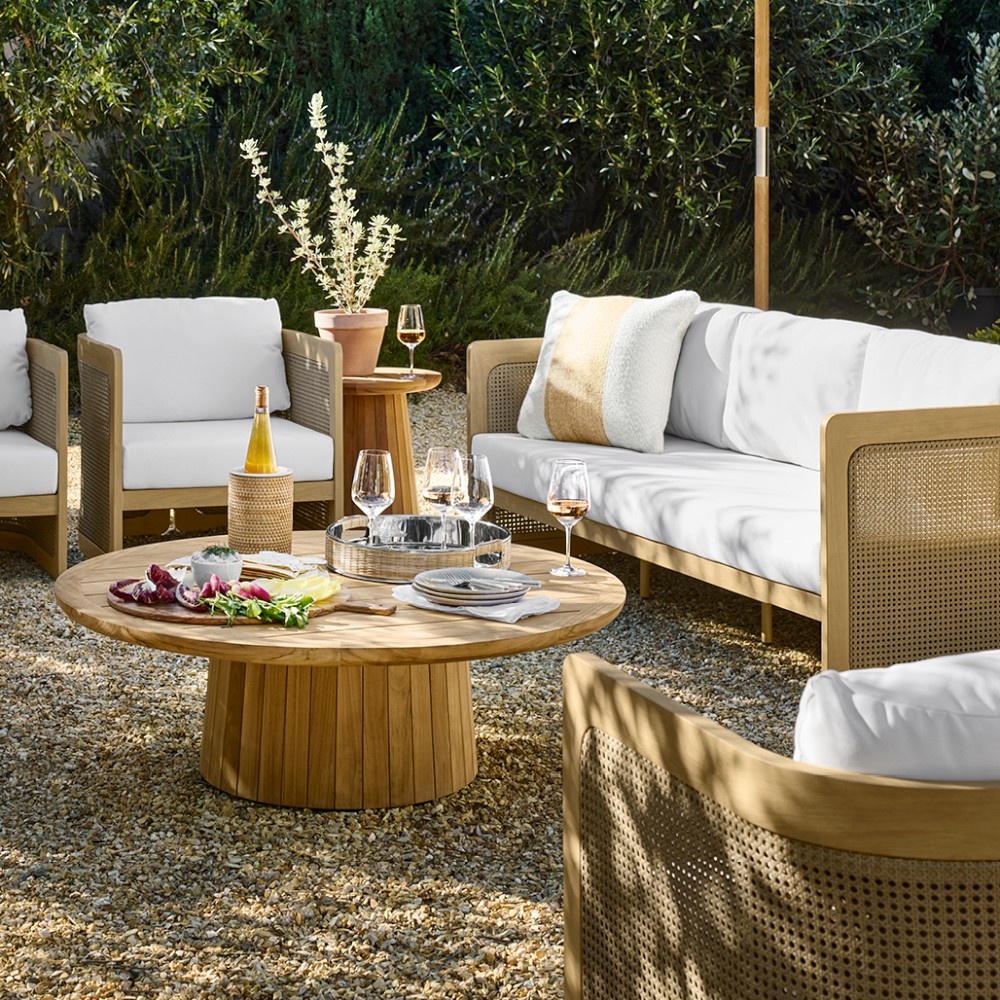 Outdoor seating ensemble with circular nesting coffee tables