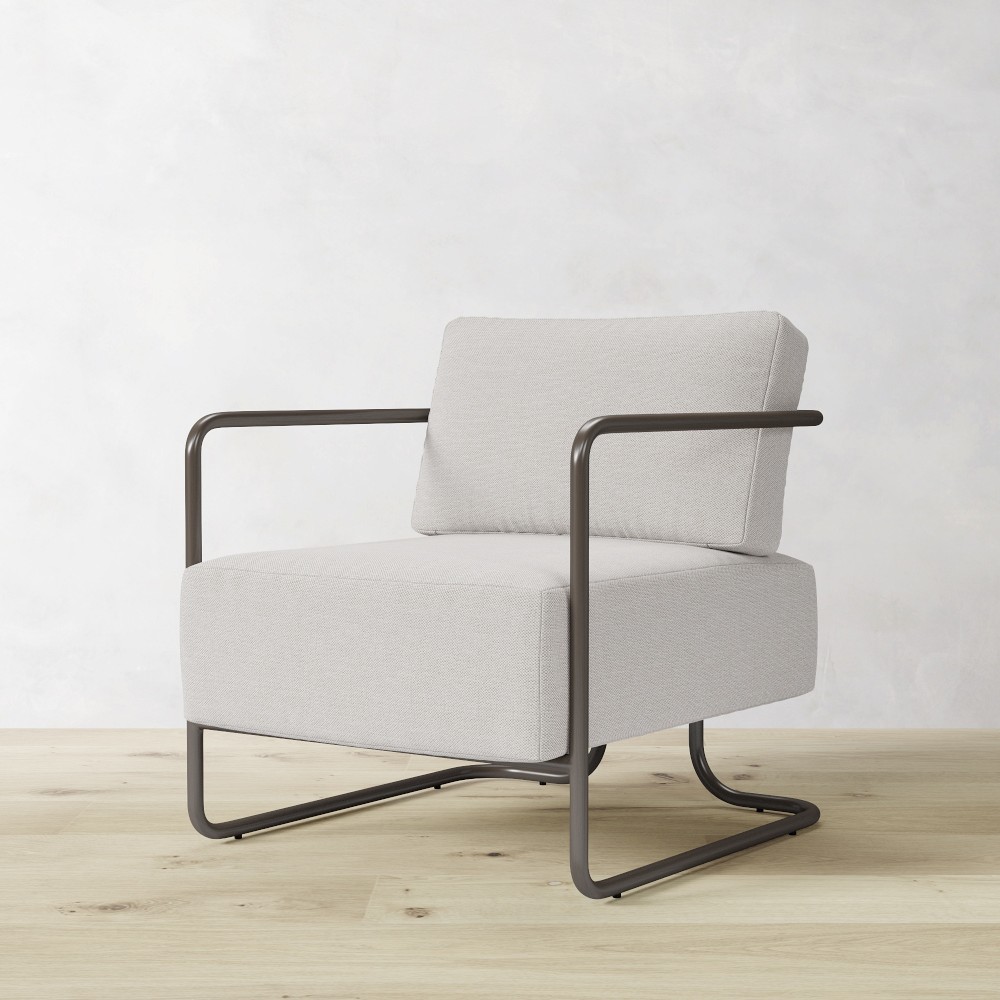 Light gray upholstered chair with matching back cushion and metal frame