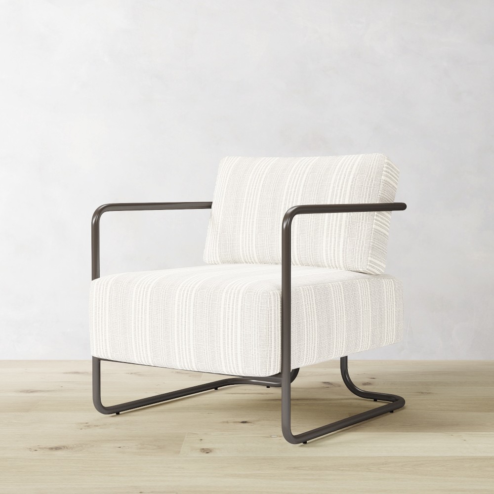 Side view of white striped outdoor chair showing cantilever frame