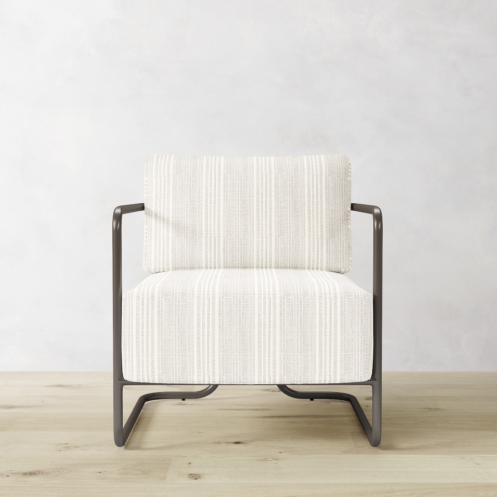 Close-up of white striped outdoor chair upholstery and dark metal frame
